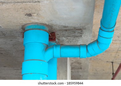 Blue PVC pipe with wall