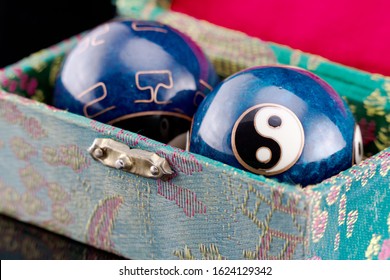 Blue Qigong balls with white yin and yang symbols