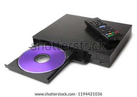 Blue Ray player with disk and remote control on white background 