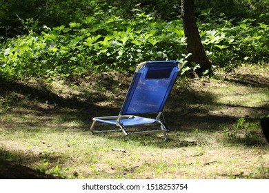 Blue Recliner Chair In A Wood With Copy Space For Your Text
