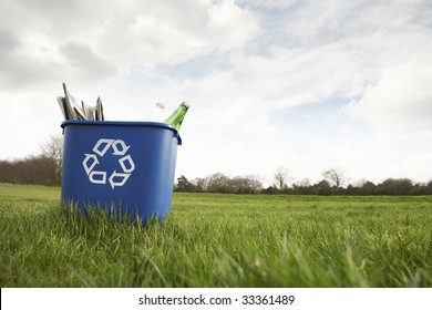 Blue Recycling Bin Sitting On Grass