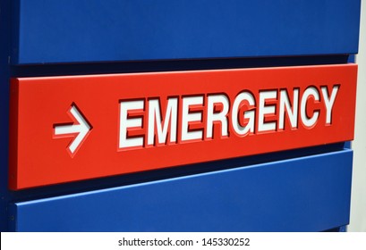 A blue and red Emergency sign outside a hospital
