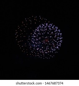 Blue And Red Fireworks In The Dark Sky.