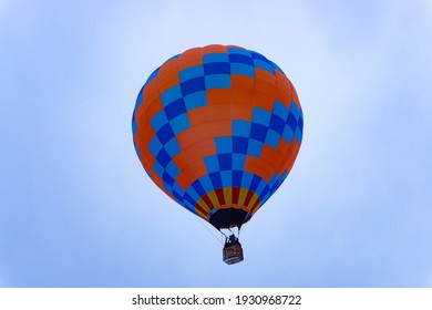 blue red hot air balloon flying into the sky