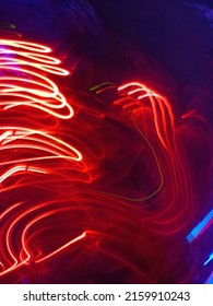 Blue And Red Light Painting Photography, Long Exposure Ripples And Waves Pattern Against A Black Background. Light Trails Long Exposure Highway. Blue And Gold Light Painting Photography, Long Exposure