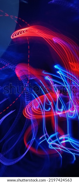 Blue and red light painting photography, long
exposure fairy blue and red lights curves and waves against a black
background. Long exposure light painting photography. Abstract pink
purple swirls
