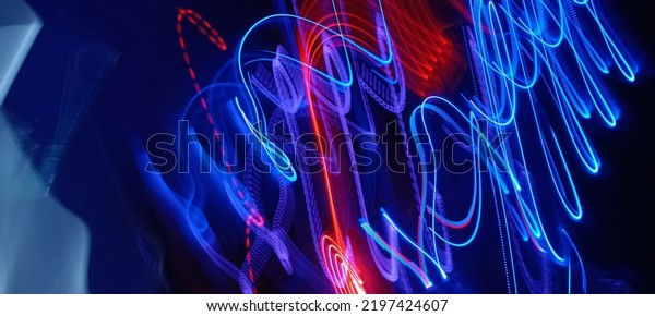 Blue and red light painting photography, long
exposure fairy blue and red lights curves and waves against a black
background. Long exposure light painting photography. Abstract pink
purple swirls
