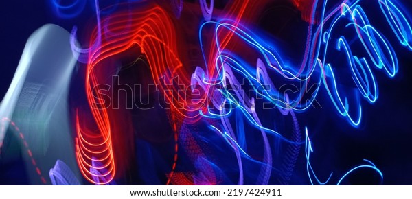 Blue and red light painting photography, long
exposure ripples and waves pattern against a black background.
Light trails long exposure highway. Blue and gold light painting
photography, long exposure