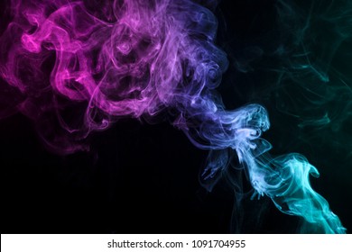 Blue, red  and pink  cloud of smoke of  black isolated background. Background from the smoke of vape