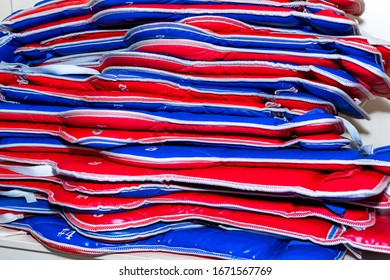 Blue And Red Taekwondo Protective Gear Is Stacked.  Protectors, Vests. Blue And Red Protective Gear Of Different Sizes For Taekwondo Lies In A Pile.  Protectors, Vests.