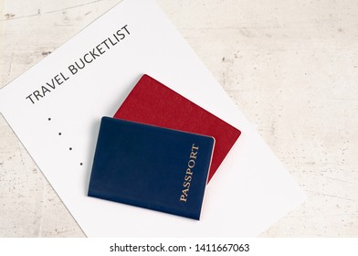 Blue And Red Travel Passports On A Light Background, Next To The Inscription Travel Bucketlist