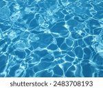 Blue reflective water in a swimming pool. Background. Top view.