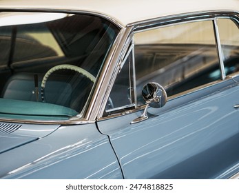 Blue retro car windscreen with steering wheel and rearview mirror. - Powered by Shutterstock