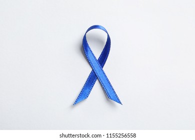 Blue Ribbon On White Background, Top View. Cancer Awareness