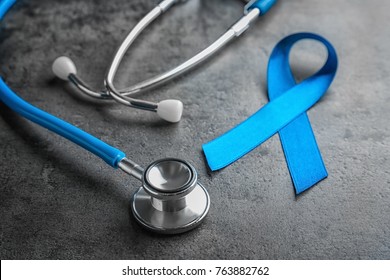 Blue ribbon and stethoscope on grey background. Cancer awareness concept - Powered by Shutterstock