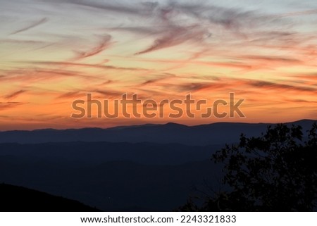 The blue Ridge Mountains at a orange sunset from Reddish Knob. the Appalachian mountains of west Virginia an Virginia. With the foreground silhouetted against the distance blue mountains,