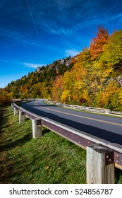 Blue Ridge Parkway In Fall With Blue Sky From Low Angle Side Of Road