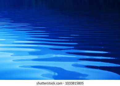 Blue Rippled Water As Abstract Background. Tranquil Surface Texture Of The Lake.