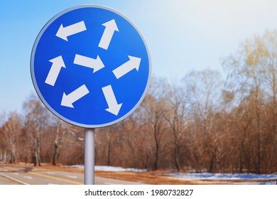 Blue Road Sign With White Arrows Pointing In Different Directions. The Concept Of Uncertainty, Traffic Rules, Business