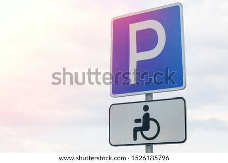Blue roadsign Parking lot for the handicapped people with a tablet