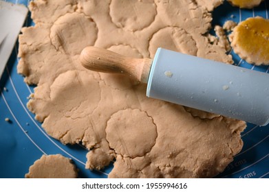 Blue Rolling Pin Made From Wood And Silicon On Cookies Dough_selective Focus