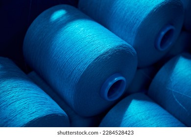 Blue rolls of industrial cotton in  weaving factory, hand weaving cotton for the fashion and textiles industry. Yarn weave traditional textile fabric manufacturing for clothing and fashion
 - Powered by Shutterstock