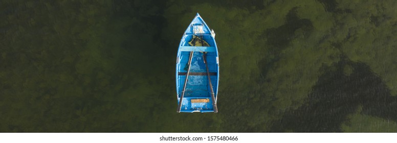 Blue Rowing Boat Top Down Aerial With Ocean Background