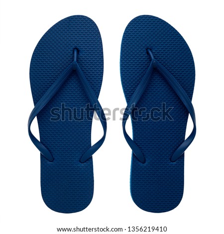 Blue rubber flip-flops isolated over white background, pair of thongs, shot above.