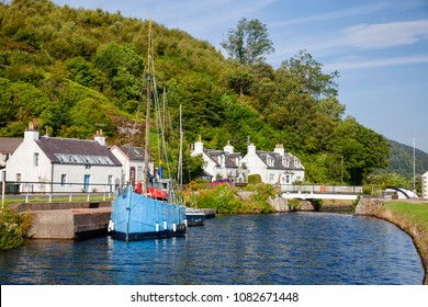 Blue sailboat moored near Bellanoch Swing Bridge at Crinan Canal connecting Crinan with Ardrishaig in Kintyre peninsula, Argyll and Bute, Scotland, UK