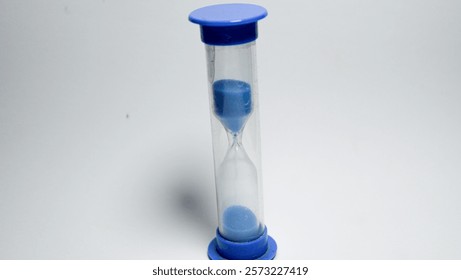 A blue sand timer isolated on white background.