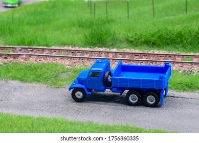 Blue scale truck on model train railroad layout road