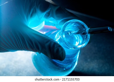 Blue science experiment glass tube,Researchers with chemistry test tubes in a liquid glass lab for analytical, medical, pharmaceutical and scientific research concepts - Shutterstock ID 2171155703
