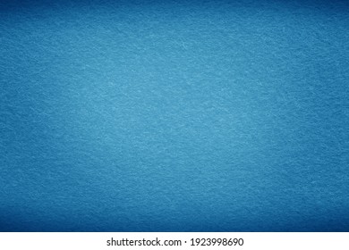 Blue sea background texture with dark vignette. Blue felt fabric background with copy space for design. 