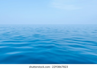 Blue sea with gentle waves and a sky of the same color as the sea, a peaceful ocean with small waves that are pleasing to the eye - Shutterstock ID 2293867823