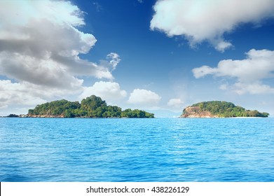 Blue Sea. Island And Beautiful Blue Sky With Clouds Background