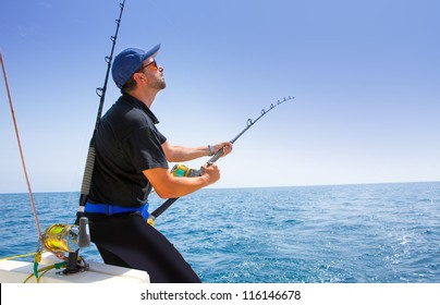 blue sea offshore fishing boat with fisherman holding rod in action