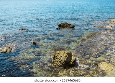 Blue sea and rocky coastline. Coastal nature and clear water landscape. - Powered by Shutterstock - Get 15% off with code: PIKWIZARD15