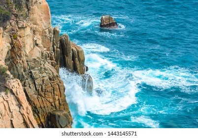 Blue sea with rocky shore in sunny afternoon, Acapulco, Mexico.