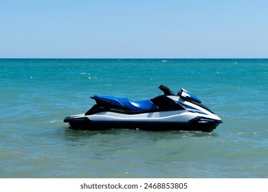 Blue sea and a ski floating on the sea. Water scooter is in the blue sea.