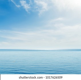 Blue Sea And Sky With Clouds