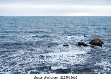 Blue sea storms on the rocky sea coast
