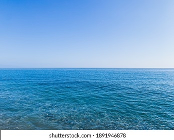 Blue Sea Surface And Clear Blue Sky