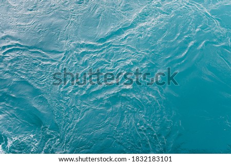 Blue sea surface with waves and ripples. Top view
