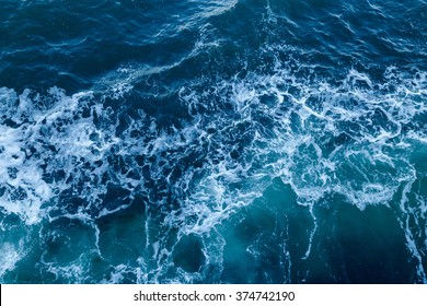 Blue sea texture with waves and foam