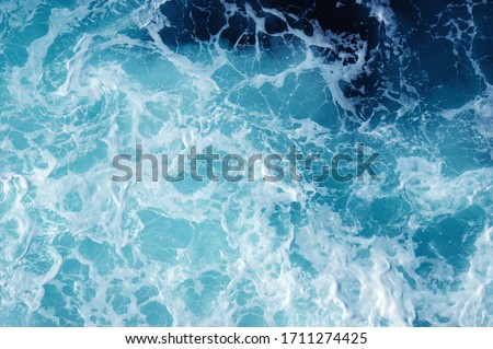 Blue sea texture with waves and foam