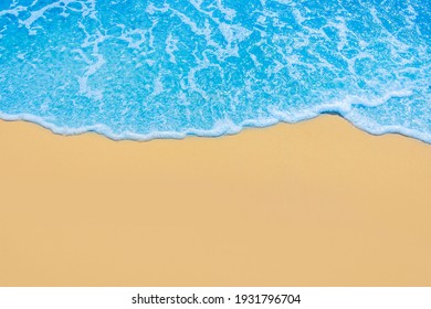 Blue Sea Water On Light Yellow Beach Sand.