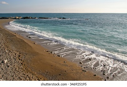 Blue sea wave is incident on the sandy shore, far breakwater. Seascape, marine - Shutterstock ID 346925195