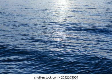 Blue Sea Waves Surface, Ripple Water Texture, Beautiful Quiet Ocean Background, Abstract Aqua Pattern Backdrop, Sunset Reflection, Sun Light Glow, Dark Night Shiny Moonlight At Lake, River, Top View