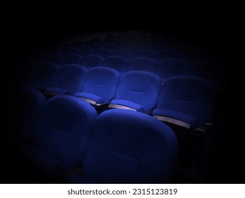 Blue seats floating in movie theater spotlights - Shutterstock ID 2315123819