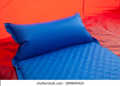 A Blue Self Inflating Blow-up Mattress Pad With An Integrated Pillow Is Placed In A Red Tent To Provide A Comfortable Sleep To Campers Or Those With A Bad Back